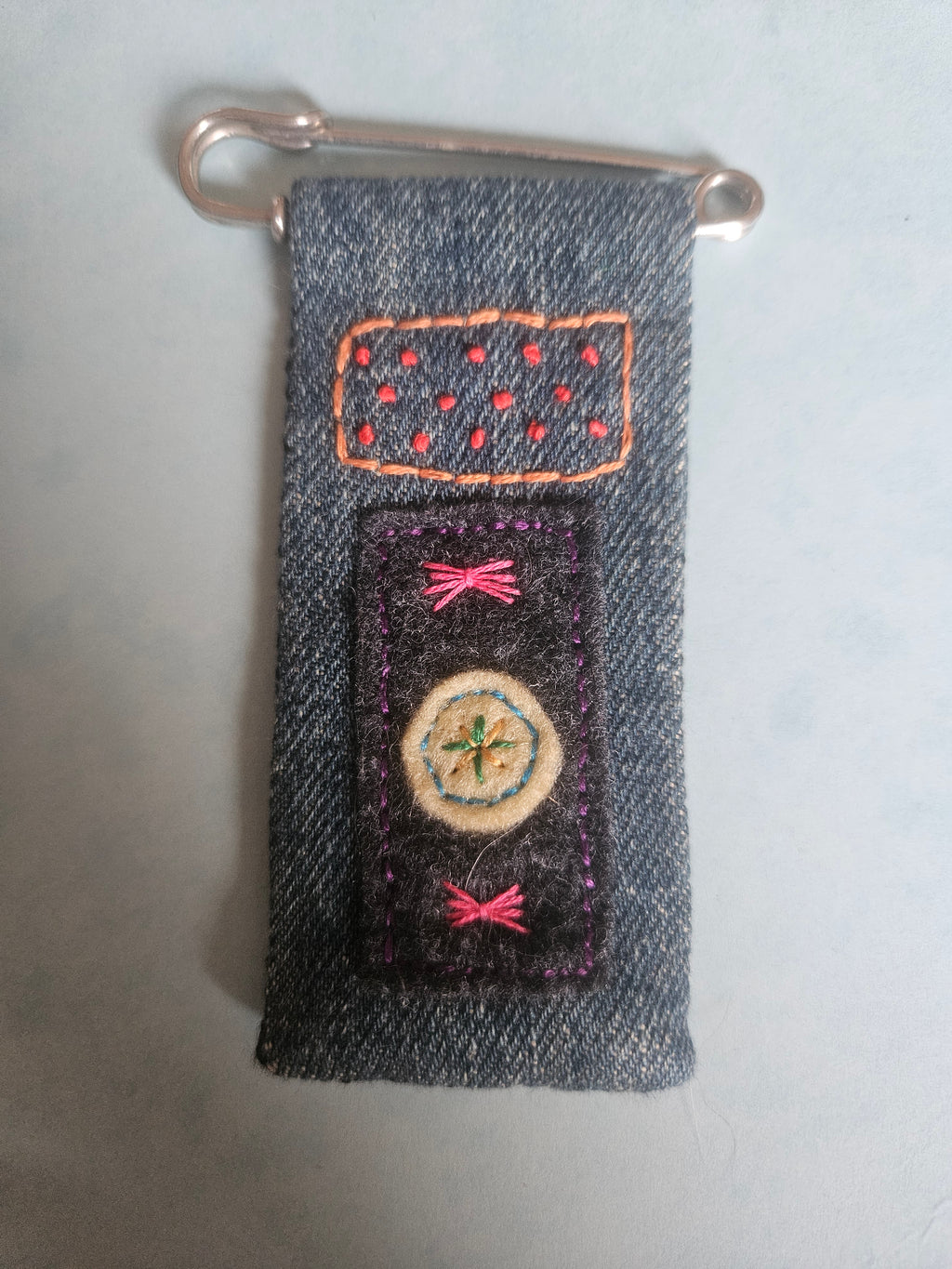 Embroidered denim on kilt pin brooch