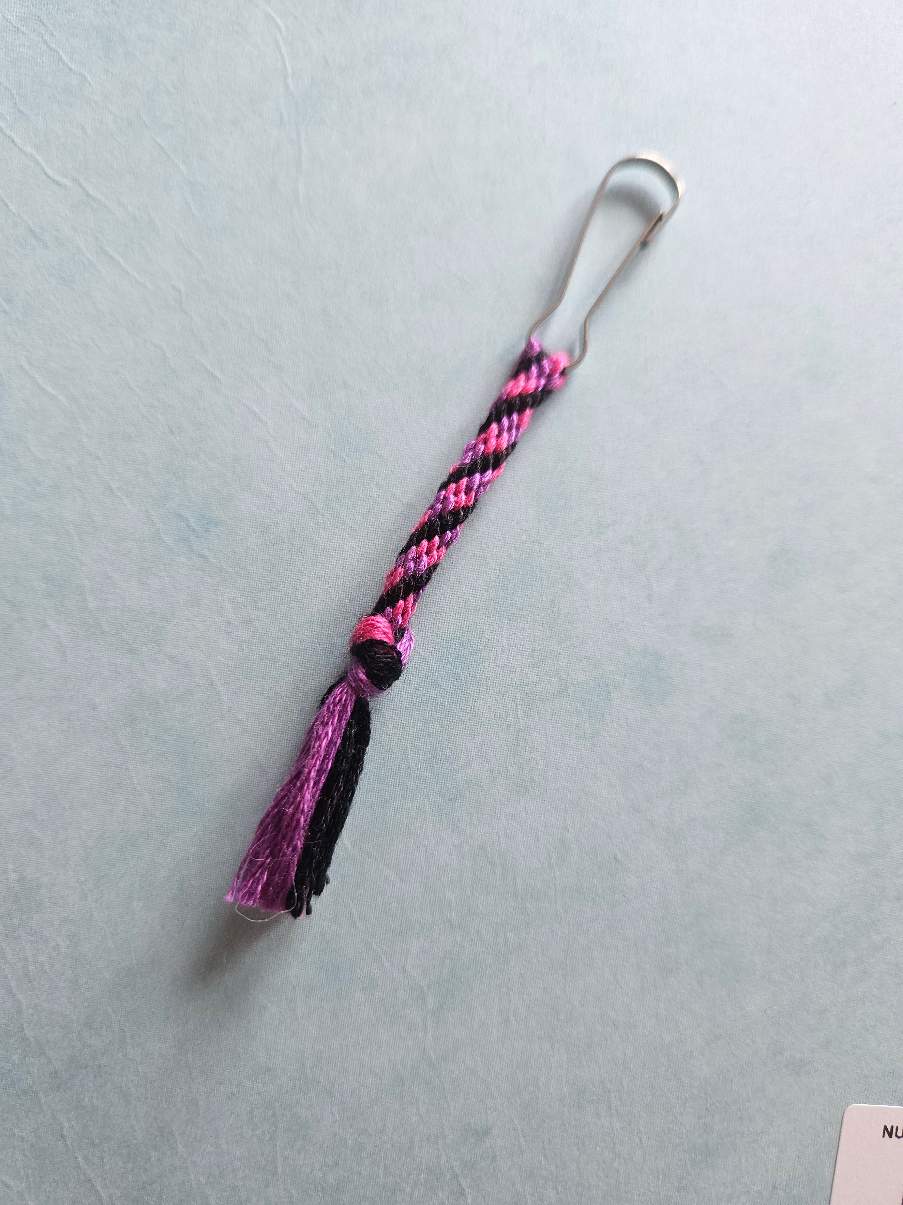 Pink, purple, and black zip clip